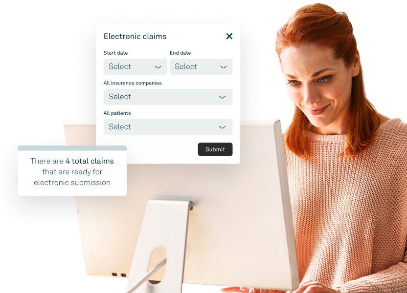Healthcare staff reviewing insurance claims on a desktop using medical billing software.