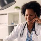 Physician smiles while working on EHR RFP