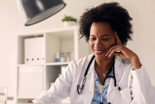 Physician smiles while working on EHR RFP