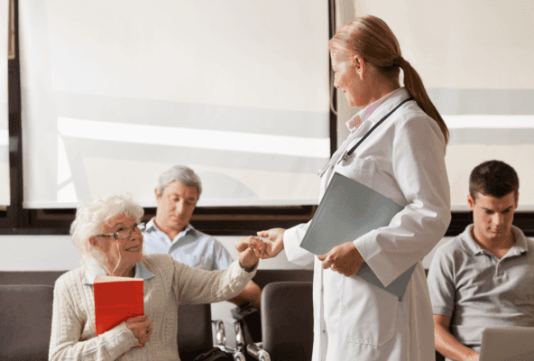 doctor holding hand of elderly patient