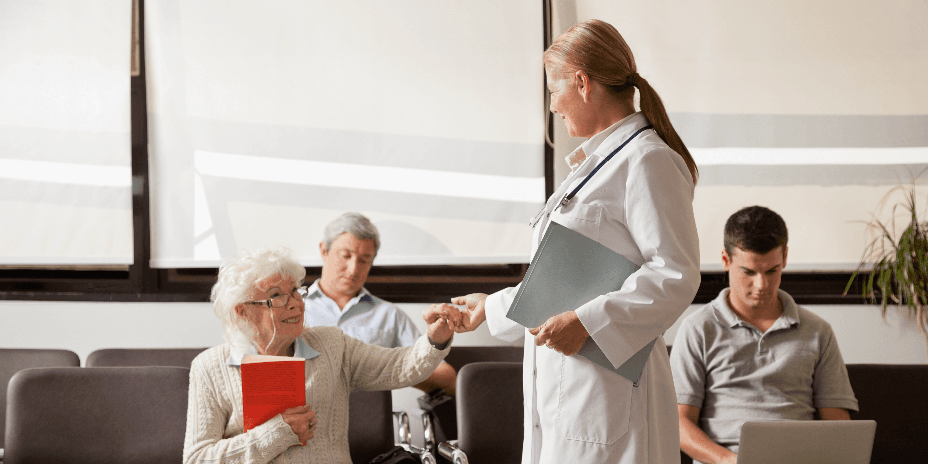 doctor holding hand of elderly patient