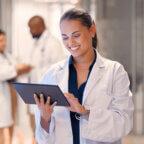 Physician reads about ehr implementation on tablet