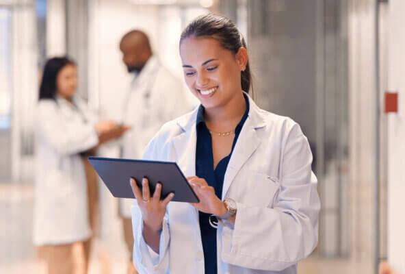 Physician reads about ehr implementation on tablet