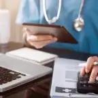 hand of medical professional using calculator