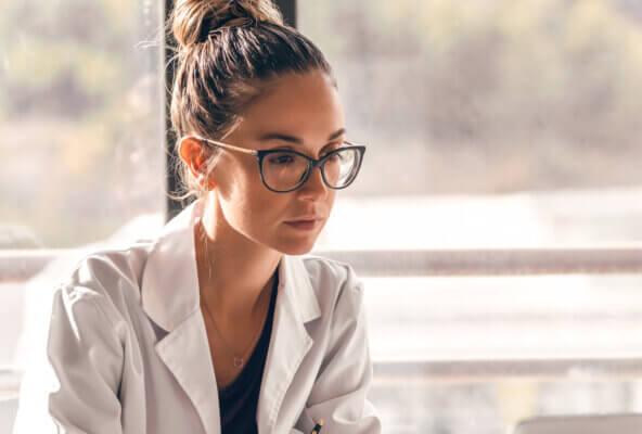 Independent practice physician reads news about Trump healthcare policy on computer