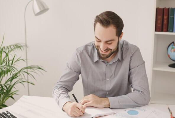 medical administrative staff member smiling after reviewing data of improved efficiency