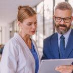 Physicians discuss cost transparency in healthcare while looking at tablet