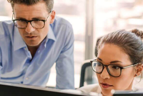 Medical practice staff look at computer working on verifying medical insurance eligibility