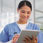 Medical professional reads about history of electronic health records on tablet