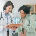 doctors in clinic setting looking at charts together