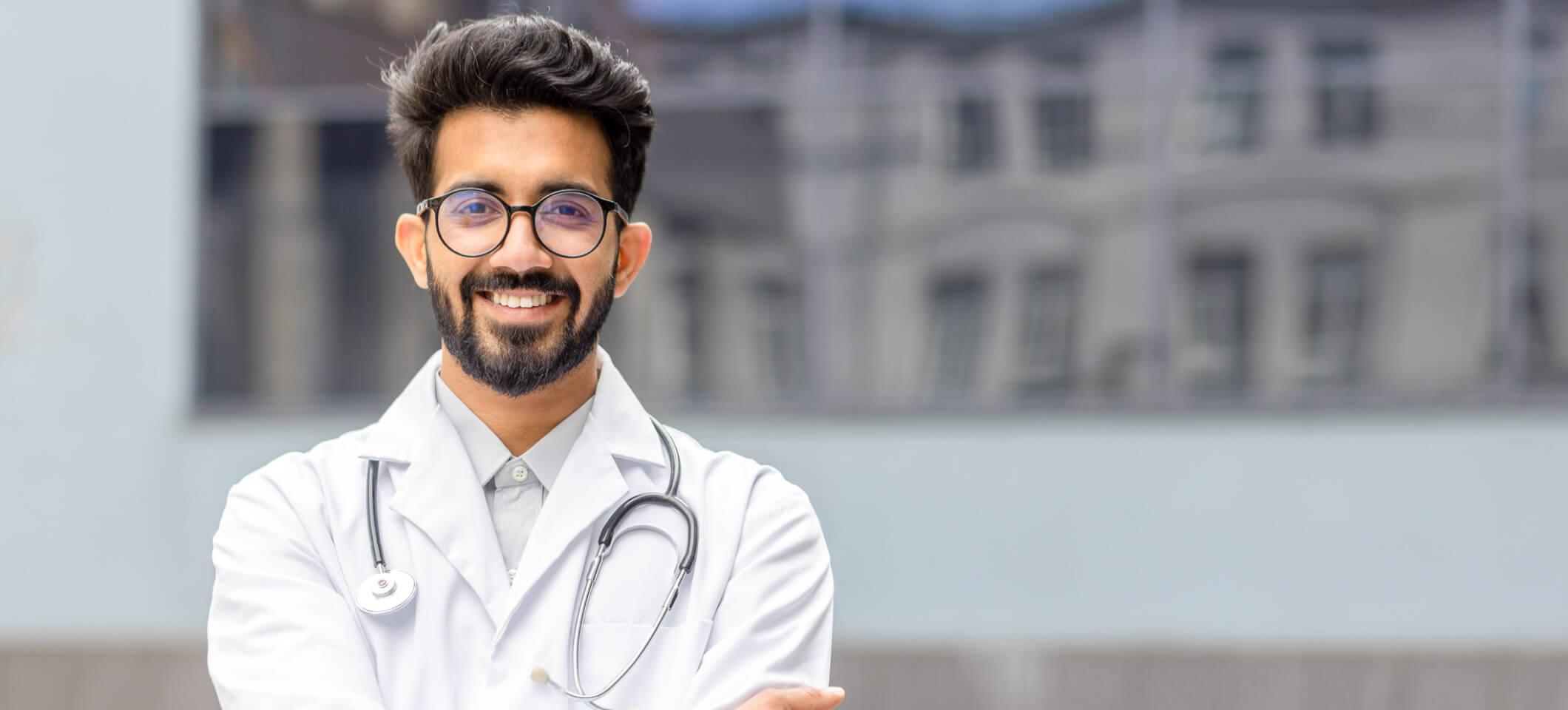 Doctor smiles at camera after reading about CY 2025 Medicare Physician Fee Schedule Final Rule