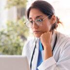 Physician reads on computer about HIPAA breach notification rule